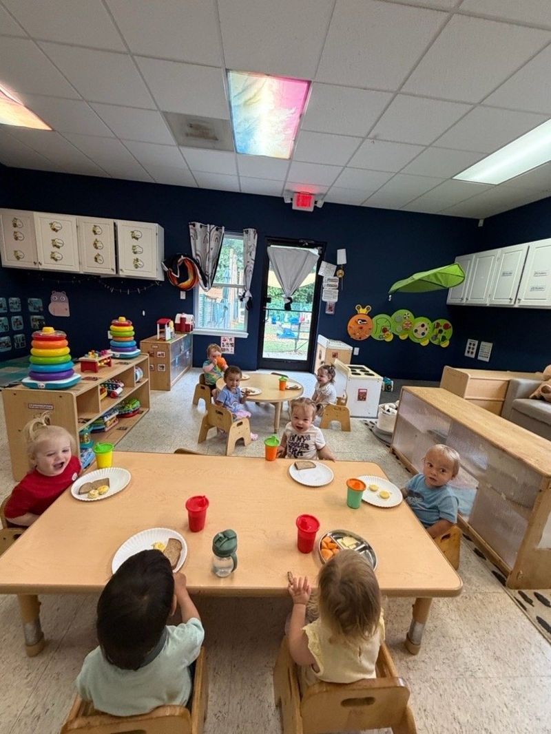 Infants and toddlers gathered for a classroom meal