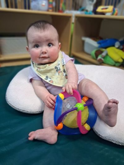 Infant enjoying a colorful classroom toy